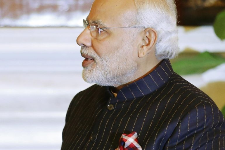 Indian Prime Minister Modi, wearing a dark pinstripe suit repeatedly embroidered with the words "Narendra Damodardas Modi", meets with U.S. President Barack Obama in New Delhi