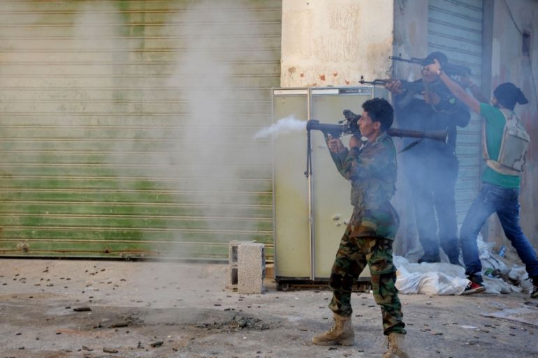Libyan military soldiers fire their weapons during clashes with Islamic militias in Benghazi [AP]