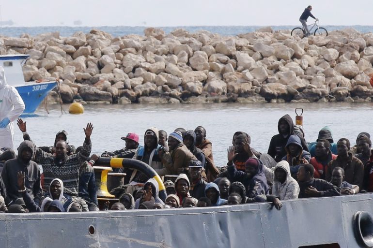 Migrants arrive by boat at the Sicilian harbour of Pozzallo