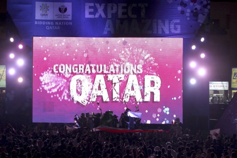 File photo of people celebrating in front of a screen that reads "Congratulations Qatar" after FIFA announced that Qatar will be host of the 2022 World Cup in Souq Waqif in Doha
