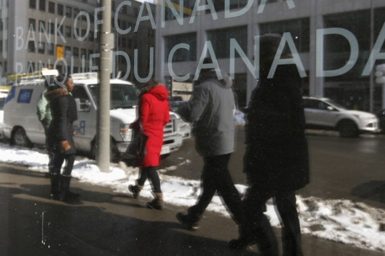 Pedestrians walk past the Bank of Canada office in Ottawa
