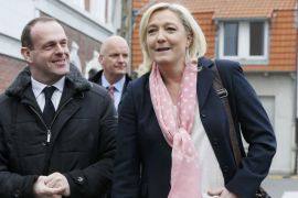 France''s far-right National Front leader Marine Le Pen and Mayor of Henin-Beaumont Steeve Briois leave a polling station after she voted in Henin-Beaumont, northern France