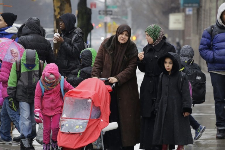 Muslim women accompany their children at the end of a school day, in the Brooklyn borough of New York [AP]