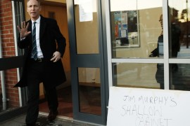 Scotland''s Labour Party leader Murphy passes a heckler''s placard while campaigning in Dundee, Scotland