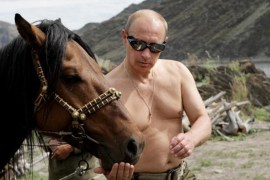 Russian Prime Minister Vladimir Putin is pictured with a horse during his vacation outside the town of Kyzyl in Southern Siberia on August 3, 2009.