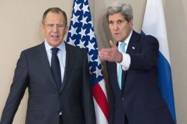 U.S. Secretary of State John Kerry gestures next to Russian Foreign Minister Sergei Lavrov during their meeting in Geneva