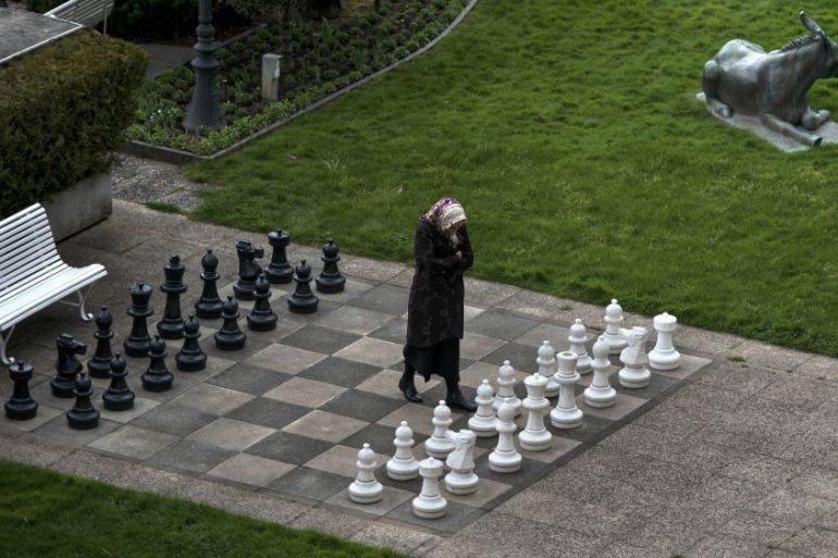 A member of the Iranian media walks on an open air chess board at the site of negotiations about Iran''s nuclear program in Lausanne, Switzerland [AP]