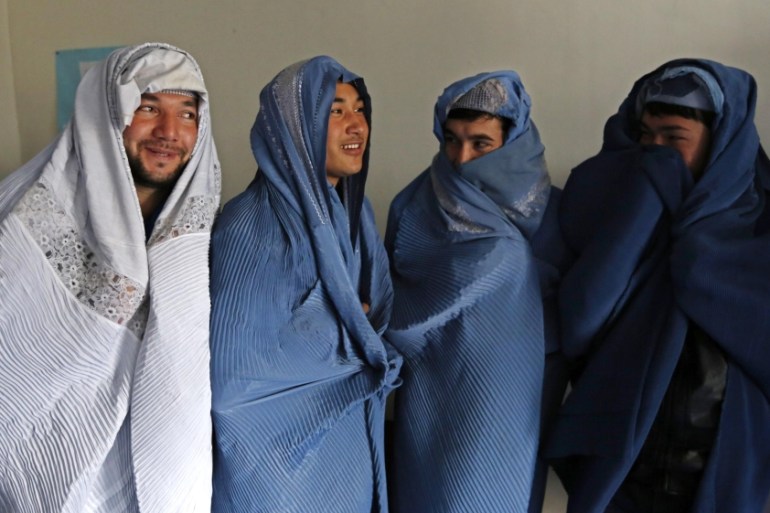 Male Afghan women''s rights activists pose for media as they wear burqas to show solidarity to Afghan women ahead of International Women''s Day in Kabul