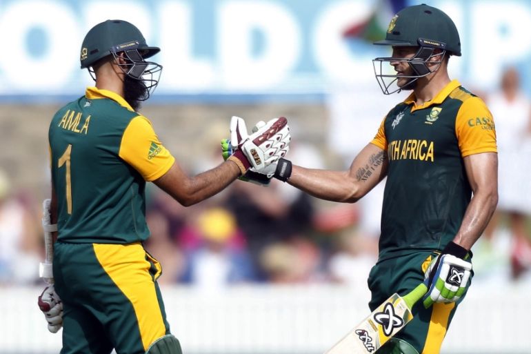 South Africa''s Hashim Amla celebrates with team mate Faf du Plessis after reaching his century during the Cricket World Cup match against Ireland at Manuka Oval in Canberra