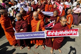 Buddhist monks carry placards during a protest against a UN resolution urging Myanmar to offer Rohingyas full citizenship, Yangon, Myanmar [EPA]