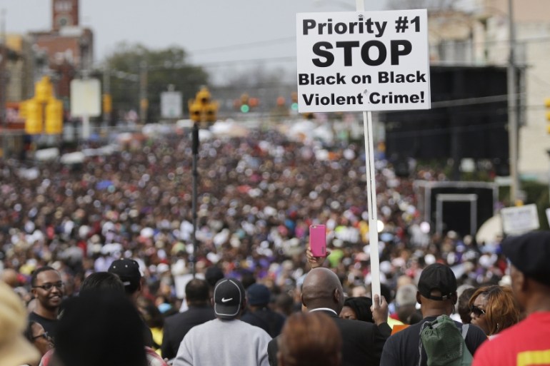 Crowds of people walk toward Selma after taking a symbolic walk across the Edmund Pettus Bridge in Selma [AP]