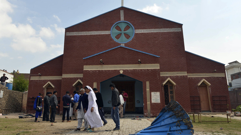 Pakistani Christians gathered in front of one of the churches that was hit by suicide bombings in Lahore [AFP]