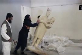 A man topples a statue in a museum said to be Mosul in this still image taken from an undated video [REUTERS]