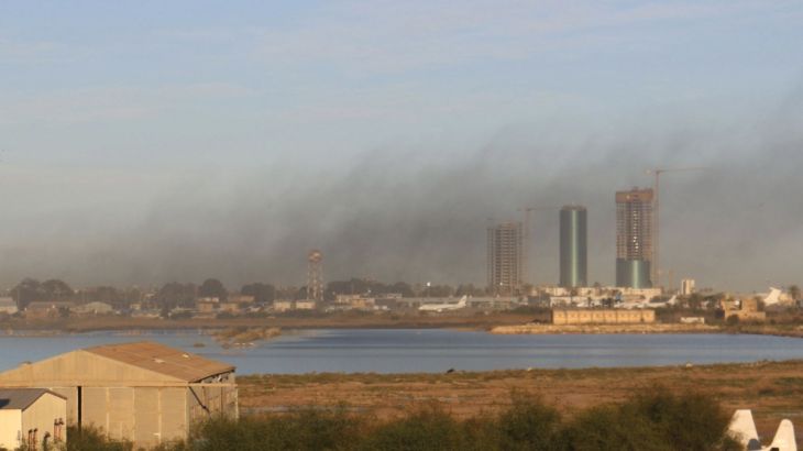 Smoke rises after an airstrike hit Maitiga airport early Thursday morning, in Tripoli