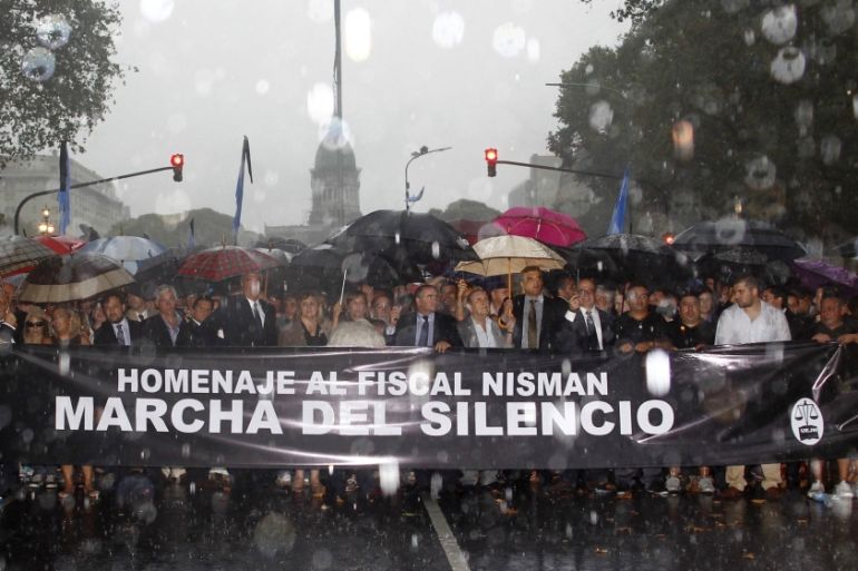 A group of prosecutors and judiciary workers lead a march under heavy rain to pay tribute to late prosecutor Nisman, a month after his mysterious death in Buenos Aires