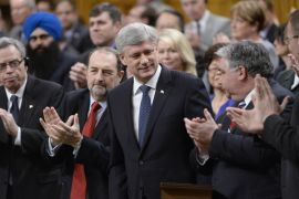 Harper is applauded after introducing a motion in the House of Commons to expand and extend Canada''s war against ISIL [AP]