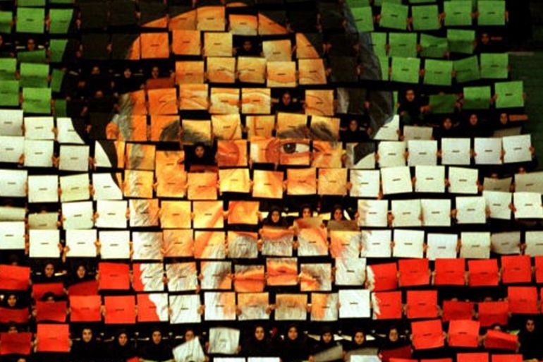 Image mosaic of Ayatollah Khomeini made up of individual boards, each in one of the three colors of the Iranian flag [Getty]