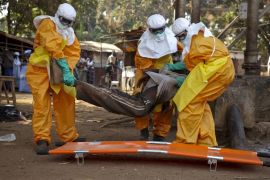 A French Red Cross team picks up a suspected Ebola case in Guinea