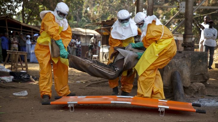 A French Red Cross team picks up a suspected Ebola case in Guinea