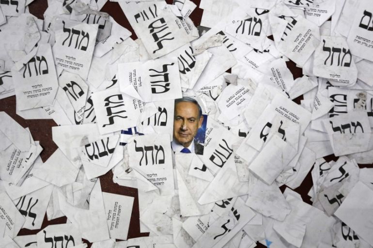 A photograph of Netanyahu is seen on the floor with Likud party ballots at Likud party headquarters in Tel Aviv [Reuters]