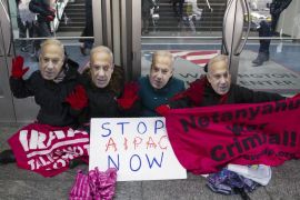 Pro-Palestine demonstrators wearing Israeli Prime Minister Benjamin Netanyahu masks, led by Code Pink, protest in front of doors of the Washington Convention Center [AP]