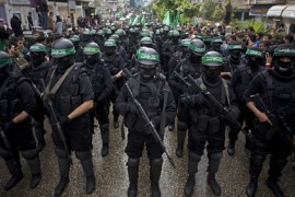 Masked Palestinian Hamas gunmen display their military skills during a rally to commemorate the 27th anniversary of the Hamas group in Gaza [AP]