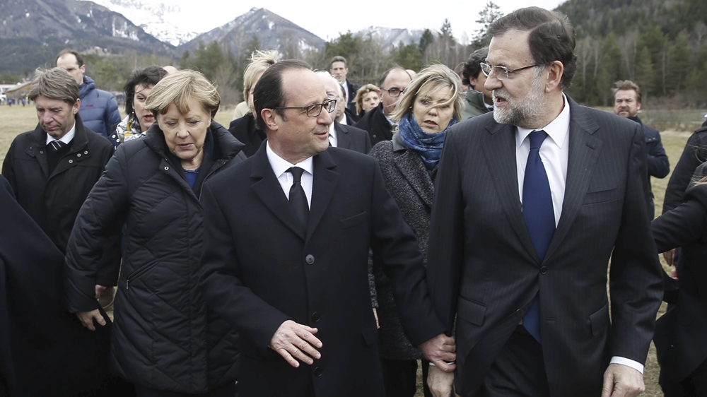 France's President Francois Hollande, Spain's Prime Minister Mariano Rajoy (R) and German Chancellor Angela Merkel walk on a field near the crash site  [Reuters]