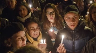 Hundreds of Tunisians held a candlelight vigil at the entrance gate of the National Bardo Museum [AP]