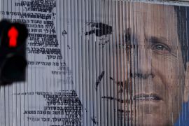 An election campaign billboard shifts between images of Herzog and Netanyahu [AP]