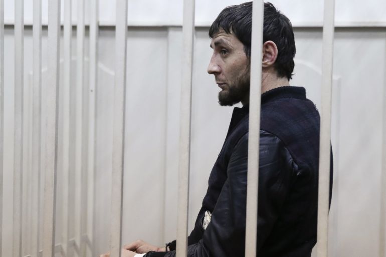 Dadayev, charged with involvement in the murder of Russian opposition figure Nemtsov, stands inside a defendants'' cage in a court building in Moscow
