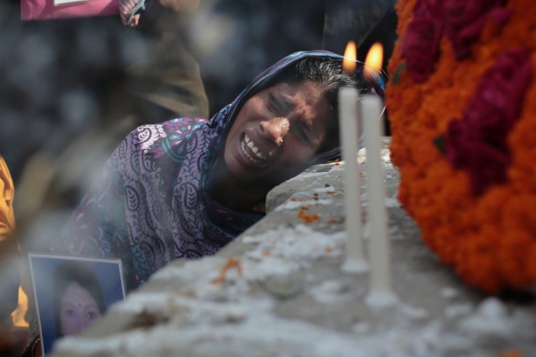 Bangladeshi relative of a victim cries in front of a monument erected in memory of the victims of Rana Plaza building collapse [AP]