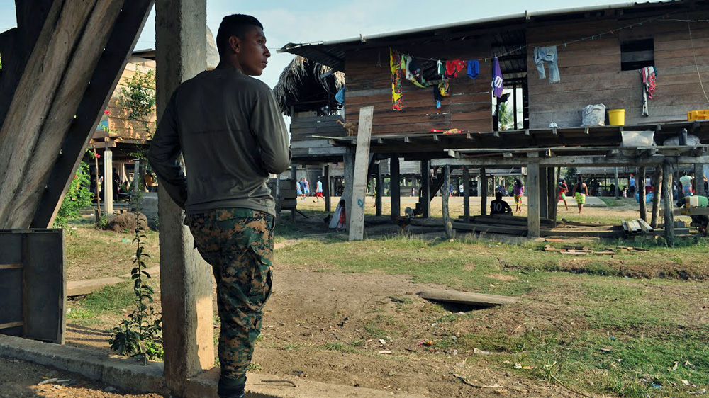 A soldier from Senafront, Panama's border police, looks out over the indigenous village of Marragantí [Joe Jackson/Al Jazeera]