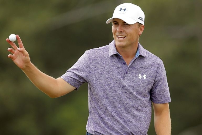 Jordan Spieth of the U.S. waves to the gallery after finishing on the 18th green at 14-under par during second round play of the Masters golf tournament at the Augusta National Golf Course in Augusta
