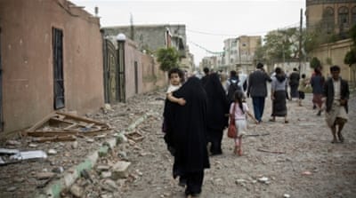 People flee after an air strike in Sanaa [AP]