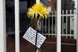 A flower and quote attributed to Nelson Mandela is tied to the front fence of Indonesia's consulate in Sydney, Australia [Reuters]