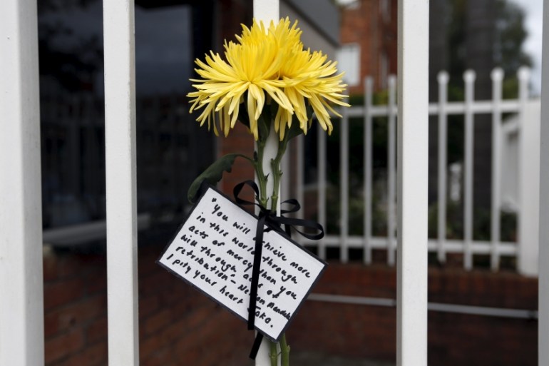 A single flower and quote attributed to Nelson Mandela is tied to the front fence of Indonesia''s Consulate in Sydney, Australia [REUTERS]