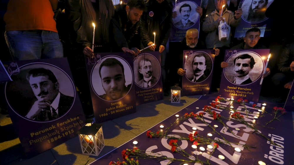 Demonstrators hold candles and pictures of victims of the 1915 mass killing during Friday's ceremonies in Istanbul [Reuters]