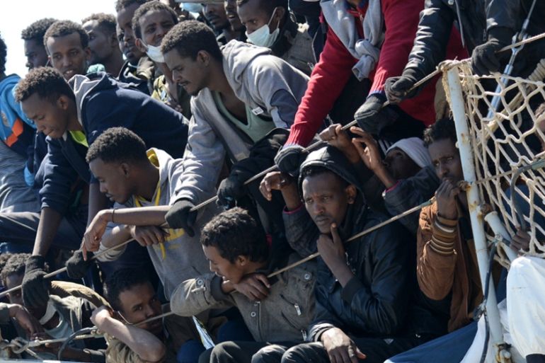 Migrants wait to disembark from the Italian Navy vessel ''Chimera'' in the harbor of Salerno [AP]