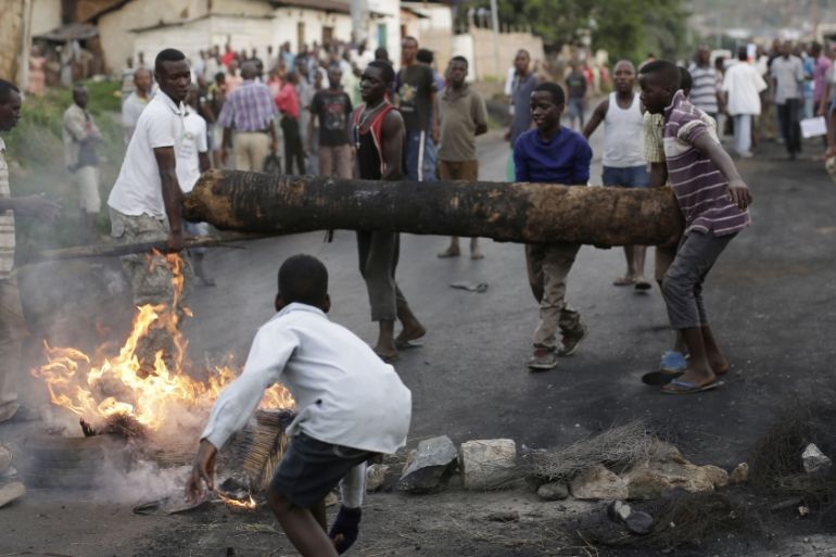 Demonstrators set up a barricade during clashes with riot police in Bujumbura, Burundi,