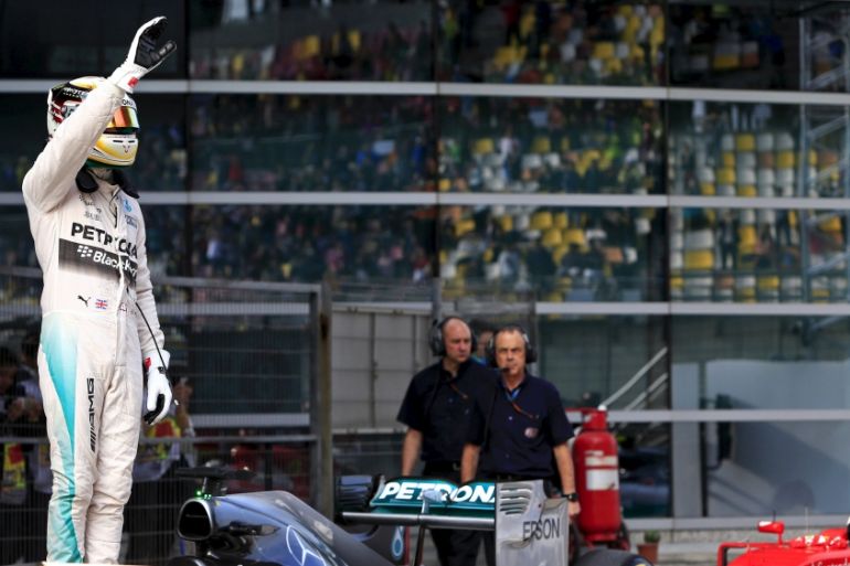 Mercedes Formula One driver Hamilton of Britain waves after taking pole position following the qualifying session of the Chinese F1 Grand Prix at Shanghai
