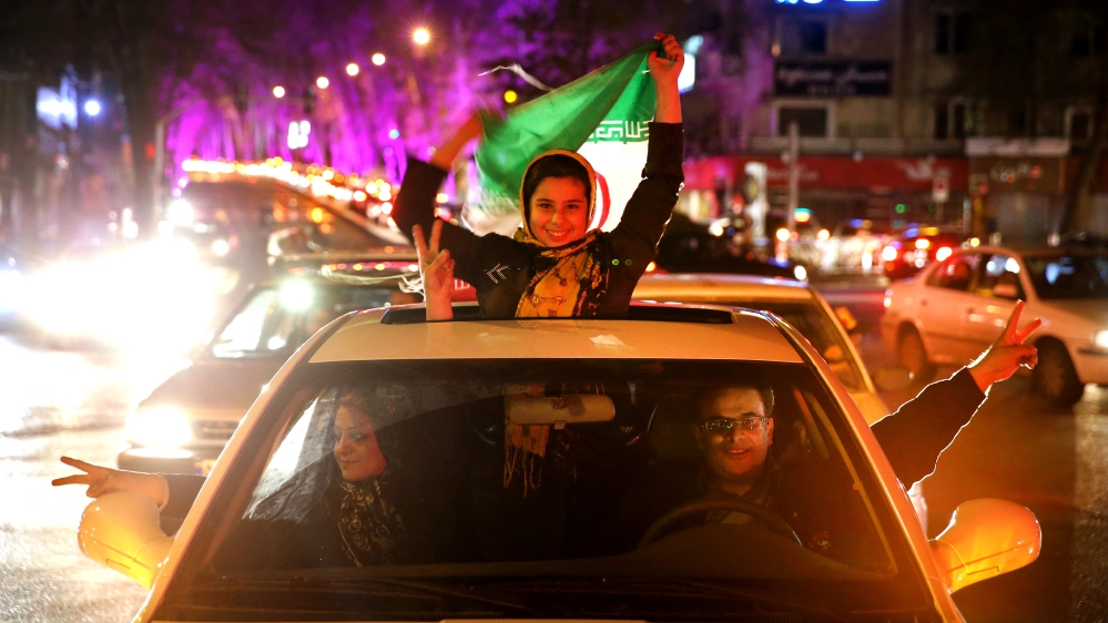 Iranians celebrate the nuclear agreement with world powers in Lausanne, on a street in northern Tehran [AP]