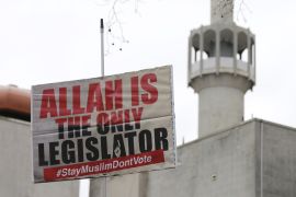 A banner calling for British Muslims not to vote as part of the Stay Muslim Don''t Vote campaign is held aloft outside the London Central Mosque in London [REUTERS]