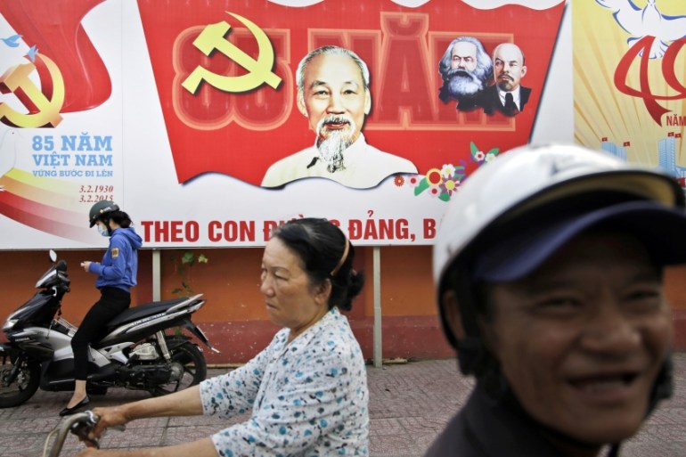 A Communist Party banner bearing portrait of Vietnamese national hero Ho Chi Minh and communist leaders Karl Marx and Vladimir Lenin is displayed on a street in Ho Chi Minh City [AP]
