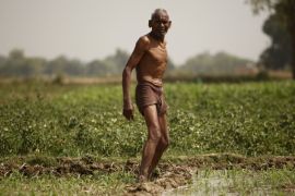 Indian farmer irrigates his field on the outskirts of Allahabad, India [AP]
