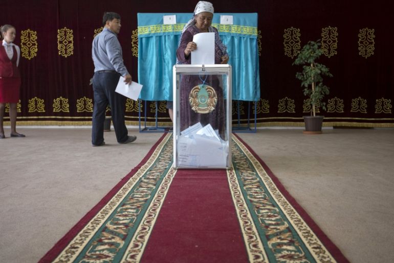 A woman casts her ballot during a snap presidential election in the village of Tuzdybastau, Kazakhstan