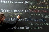 A Lebanese student writes on a wall during an event to mark the 40th anniversary of Lebanon's civil war [REUTERS]