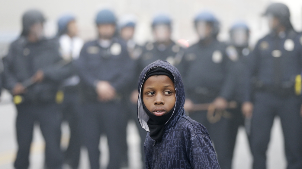 Police move a young protester following the funeral of Freddie Gray [AP]