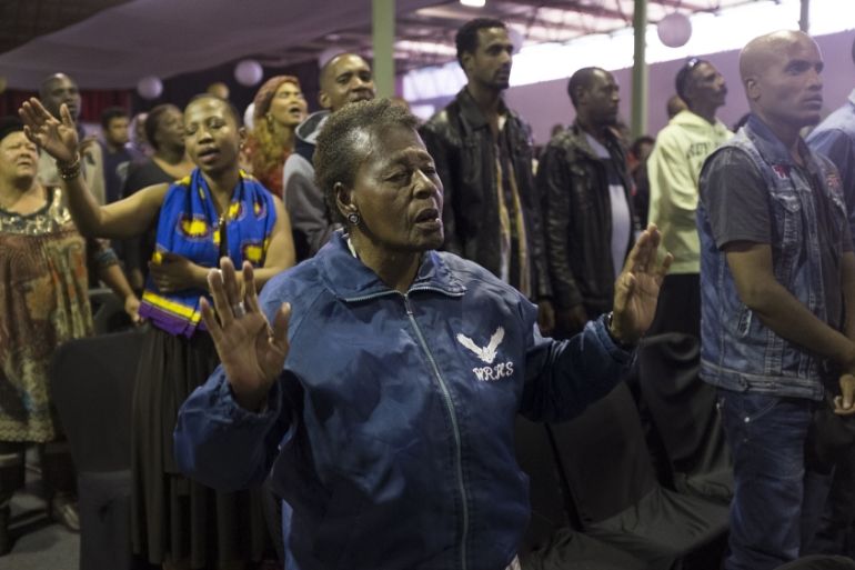 People pray for peace and friendship in the wake of violence against foreign nationals occurring in some parts of the country in Johannesburg [Getty]