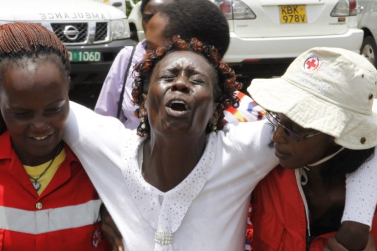 Red Cross staff console a woman after she viewed the body of a relative killed in Thursday''s attack on a university, at Chiromo funeral home, Nairobi, Kenya, Sunday, April 5, 2015. Al-Shabab gunmen ra