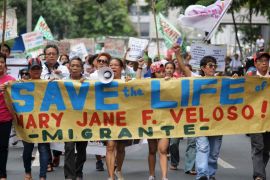 Protesters, holding placards urging the Philippine and Indonesian government to save Mary Jane Veloso, a Filipina facing execution in Indonesia, march during a demonstration in front of the Indonesian